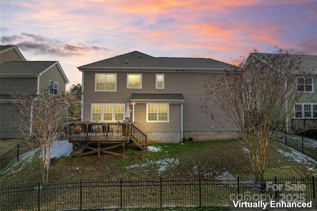 back house at dusk with a wooden deck