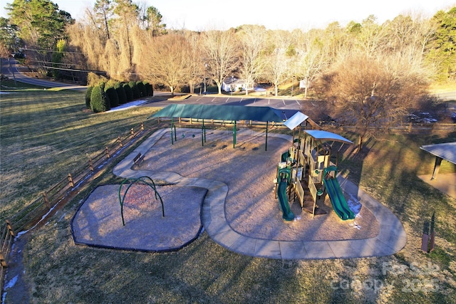 view of swimming pool featuring a playground and a lawn