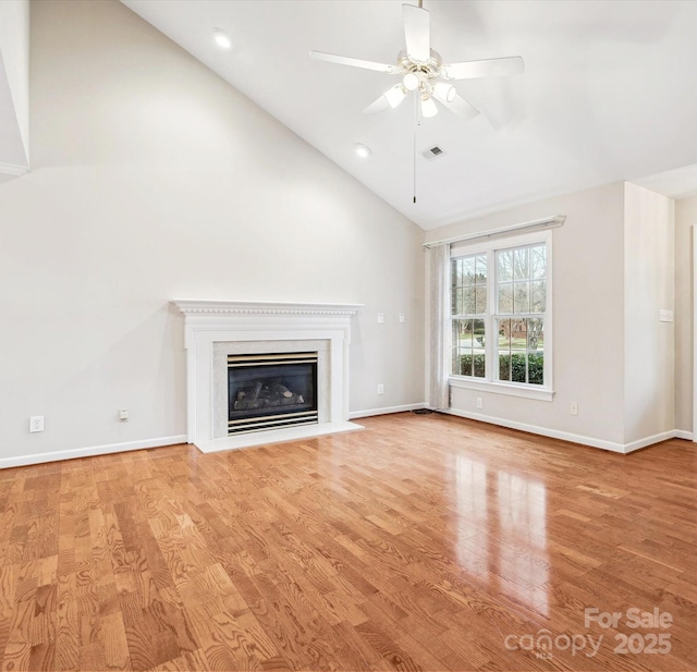 unfurnished living room with high vaulted ceiling, ceiling fan, and light hardwood / wood-style flooring