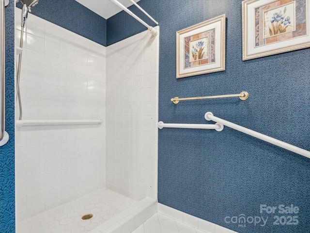 bathroom featuring tiled shower and tile patterned floors