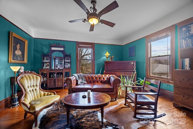 living room featuring hardwood / wood-style flooring, ceiling fan, and plenty of natural light