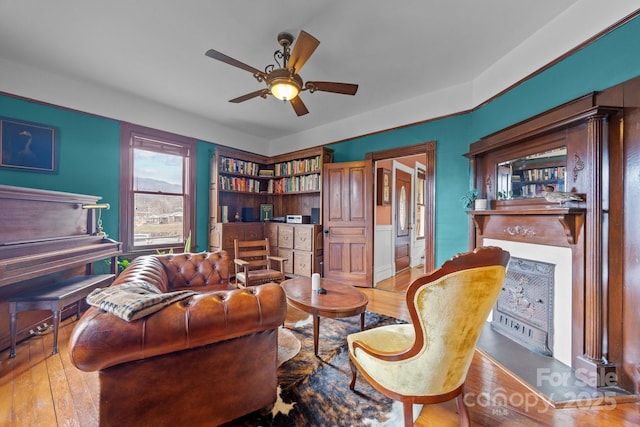 living room with ceiling fan and light hardwood / wood-style flooring