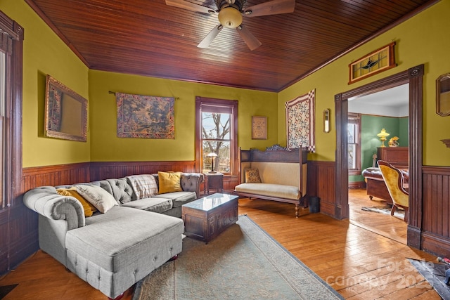 living room with crown molding, wood ceiling, and wood-type flooring