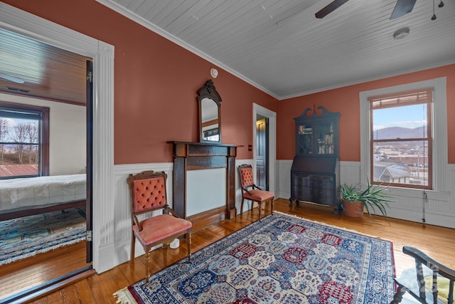 sitting room featuring crown molding, wood ceiling, hardwood / wood-style flooring, and ceiling fan