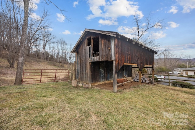 view of outbuilding featuring a yard