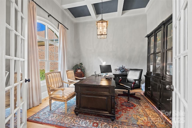 home office featuring coffered ceiling, french doors, and beamed ceiling