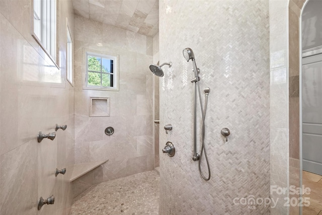 bathroom with tiled shower