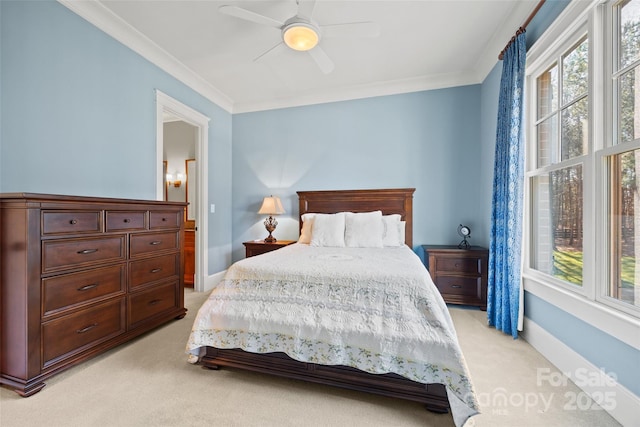 carpeted bedroom with crown molding and ceiling fan