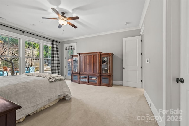 carpeted bedroom featuring ornamental molding and ceiling fan