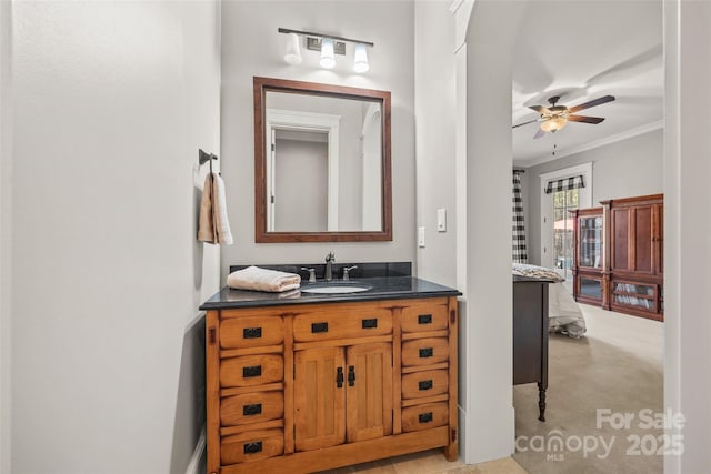 bathroom with vanity, ornamental molding, and ceiling fan