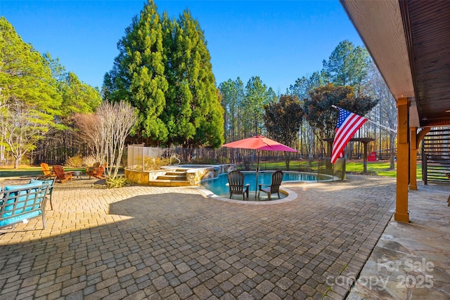 view of pool with an in ground hot tub and a patio