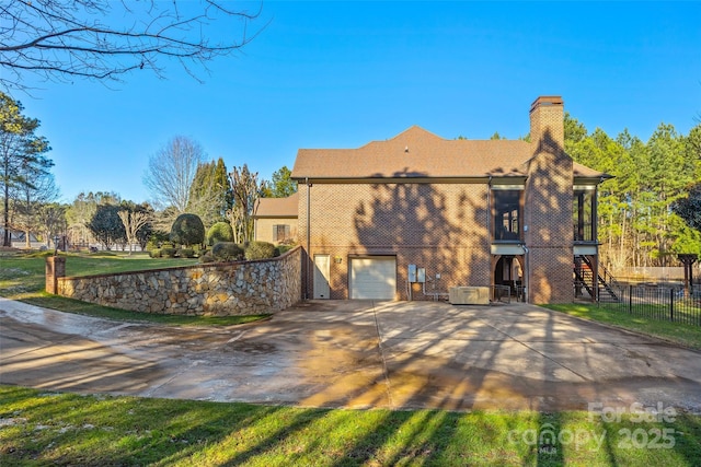 rear view of property featuring a garage