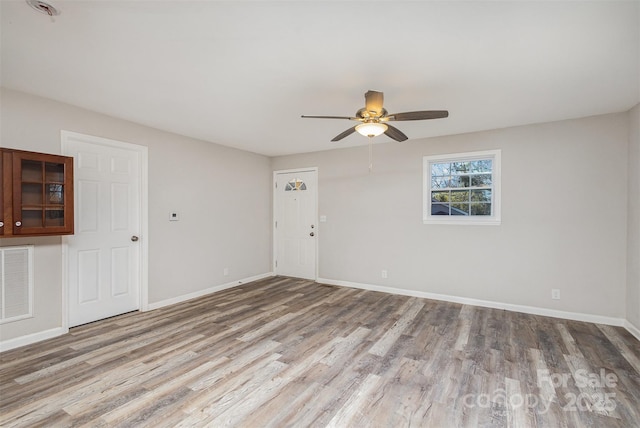 unfurnished room with ceiling fan and wood-type flooring