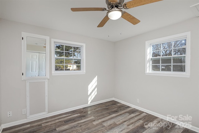 empty room with ceiling fan and dark hardwood / wood-style floors