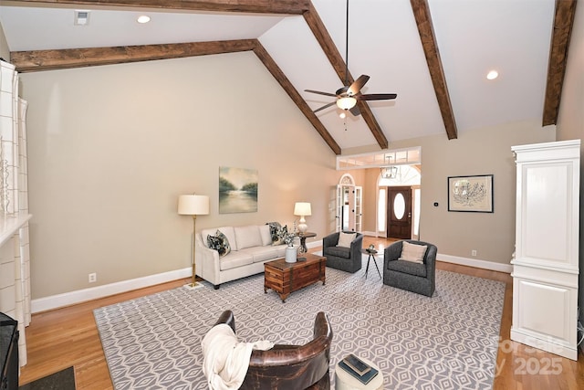 living room featuring beamed ceiling, ceiling fan, light wood-type flooring, and high vaulted ceiling