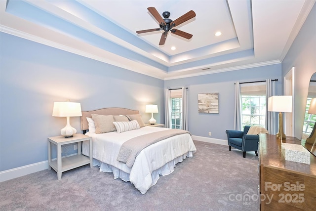 bedroom with carpet floors, a tray ceiling, ceiling fan, and crown molding