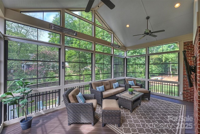 sunroom with ceiling fan and lofted ceiling