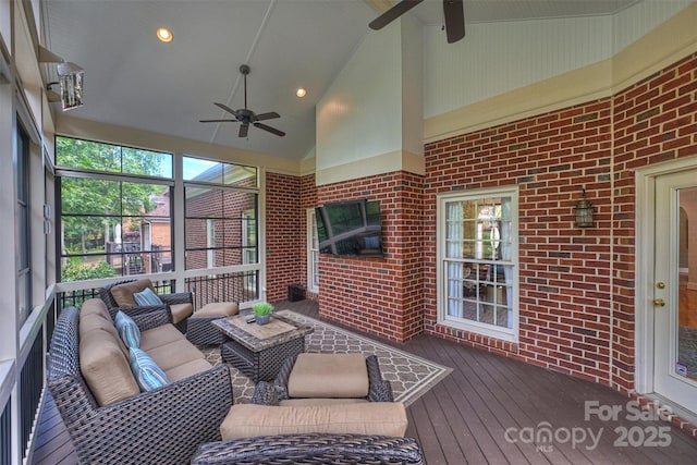 sunroom featuring a wealth of natural light, ceiling fan, and lofted ceiling