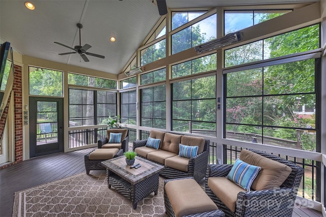 sunroom with ceiling fan, a healthy amount of sunlight, and vaulted ceiling