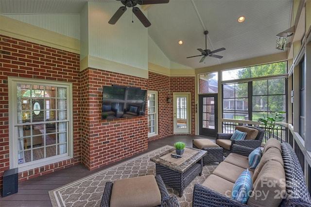 sunroom with ceiling fan and vaulted ceiling