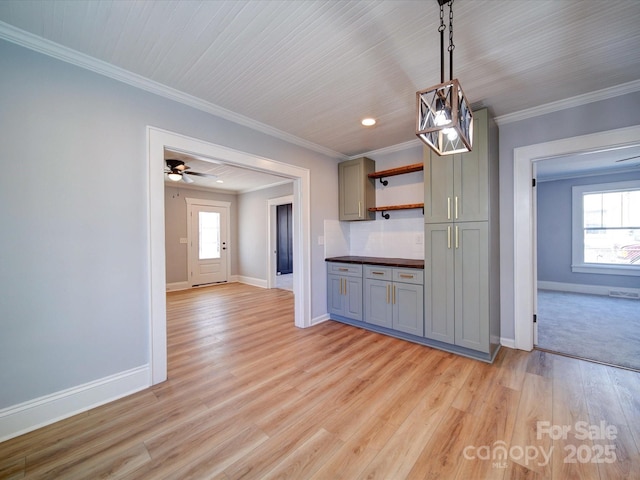 kitchen featuring pendant lighting, tasteful backsplash, gray cabinetry, ornamental molding, and light hardwood / wood-style floors