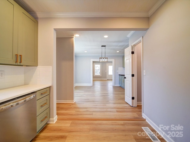 corridor with ornamental molding and light hardwood / wood-style floors