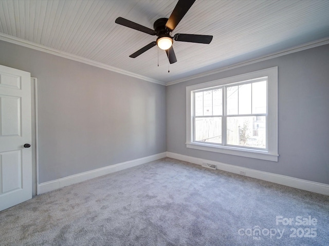 spare room with crown molding, ceiling fan, and carpet flooring