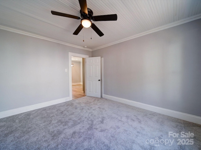 empty room with crown molding and light carpet