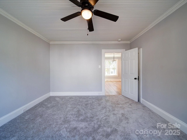 carpeted spare room with crown molding