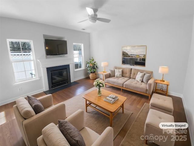 living room featuring ceiling fan and dark wood-type flooring