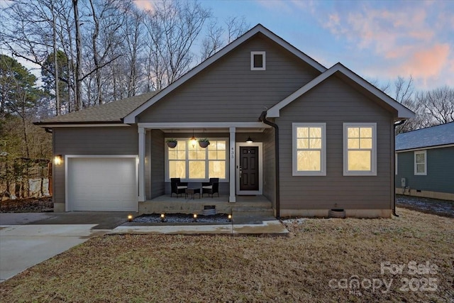 view of front of house with covered porch and a garage