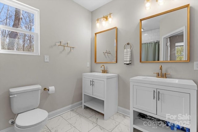 bathroom featuring vanity, toilet, a healthy amount of sunlight, and a shower with shower curtain