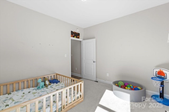 carpeted bedroom featuring a nursery area