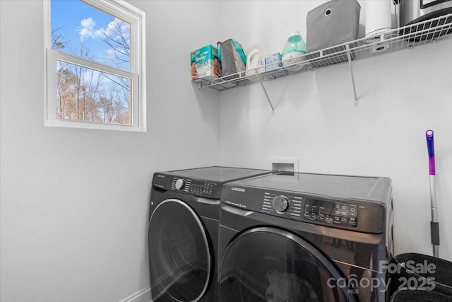 washroom with a healthy amount of sunlight and washer and clothes dryer