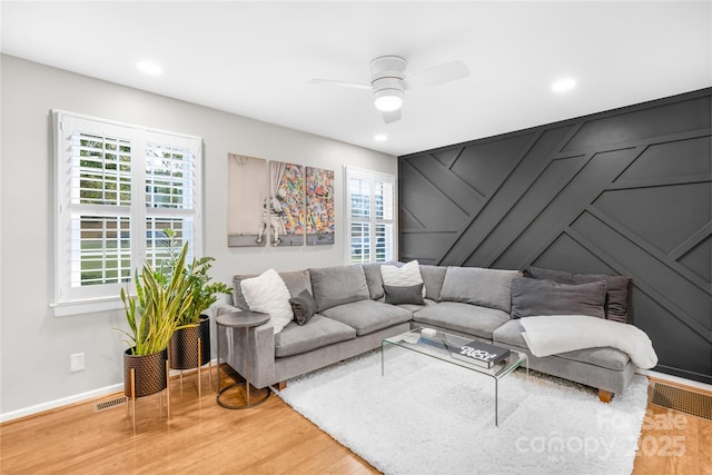 living room featuring ceiling fan, a healthy amount of sunlight, and wood-type flooring