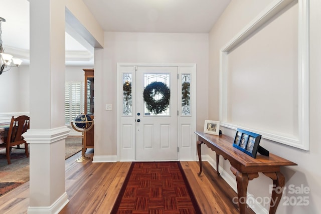 entrance foyer featuring dark parquet flooring and a chandelier