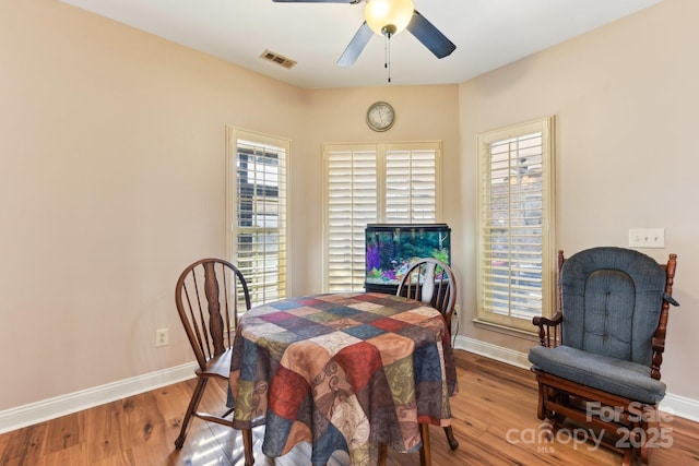 dining area with ceiling fan and hardwood / wood-style floors