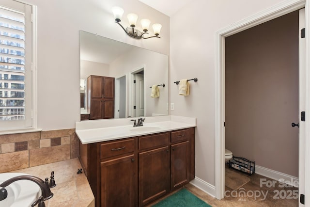 bathroom featuring tile patterned flooring, vanity, and toilet