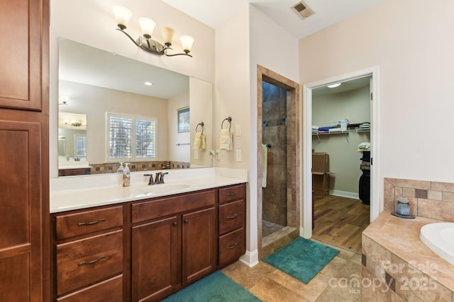 bathroom featuring vanity and separate shower and tub