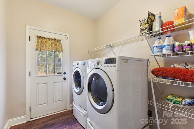 clothes washing area featuring dark wood-type flooring and washer and dryer