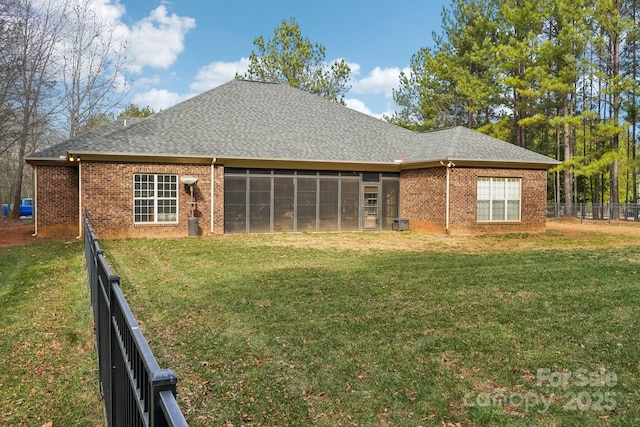 rear view of house featuring a yard