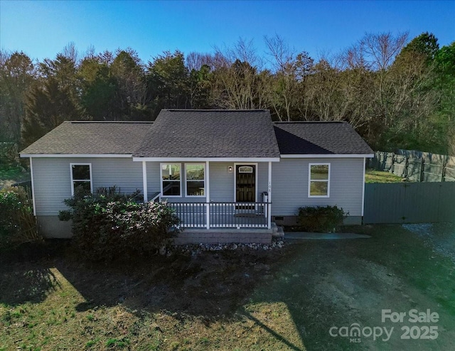 single story home with a porch and a front lawn