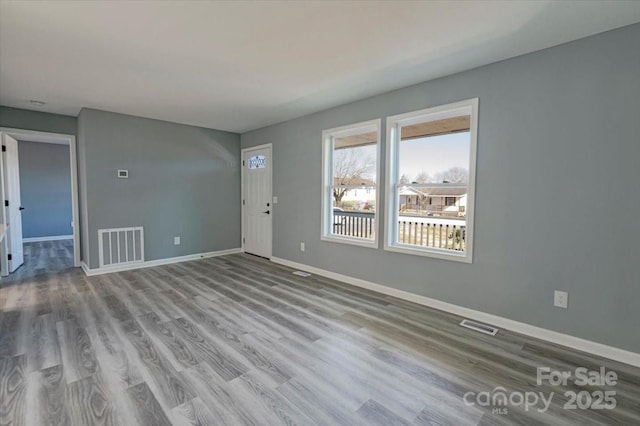 empty room with light hardwood / wood-style floors