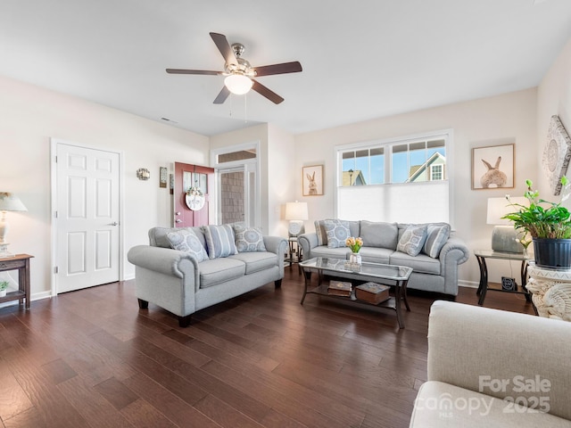 living room with ceiling fan and dark wood-type flooring