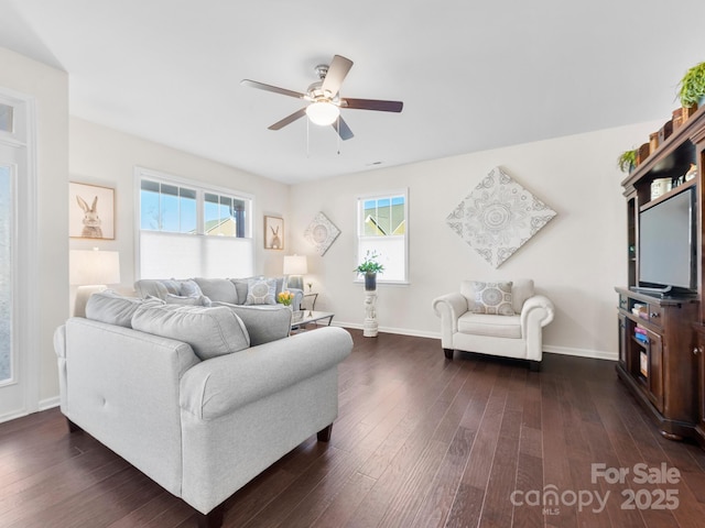 living room featuring ceiling fan and dark wood-type flooring