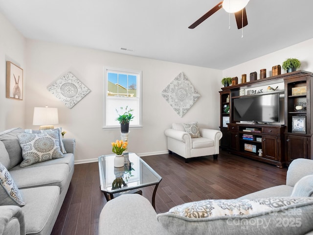 living room with ceiling fan and dark wood-type flooring