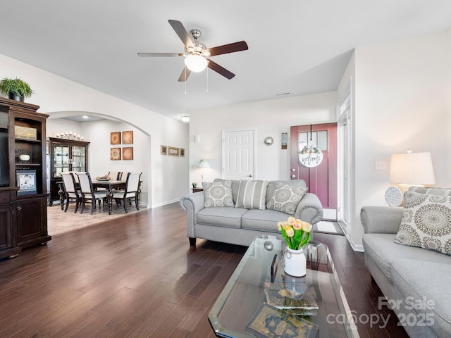 living room featuring dark hardwood / wood-style floors and ceiling fan