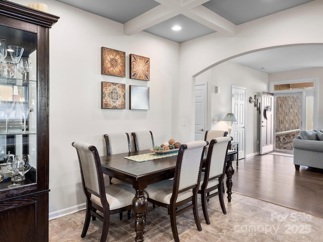 dining area featuring beam ceiling and coffered ceiling