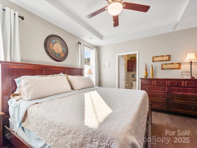 bedroom featuring ensuite bathroom, ceiling fan, and dark hardwood / wood-style floors