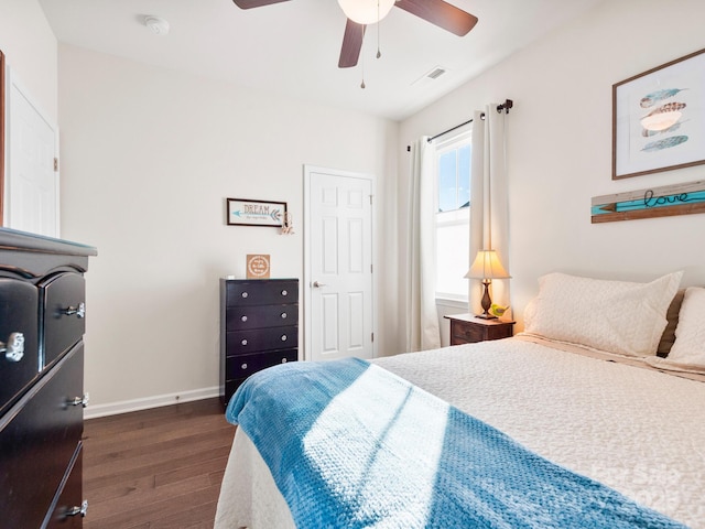 bedroom with dark hardwood / wood-style floors and ceiling fan